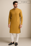 Man wearing a mustard yellow kurta with white pants on a beige background, branded 'PAEROZ'.