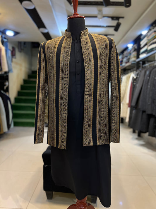 Mannequin wearing a patterned jacket and black outfit in a store setting